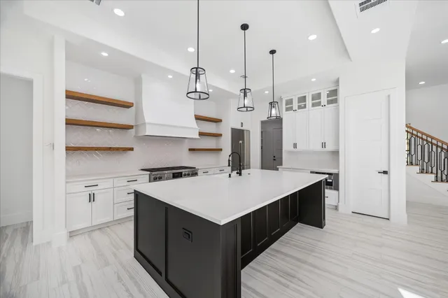 a kitchen with kitchen island a sink stove and wooden floor