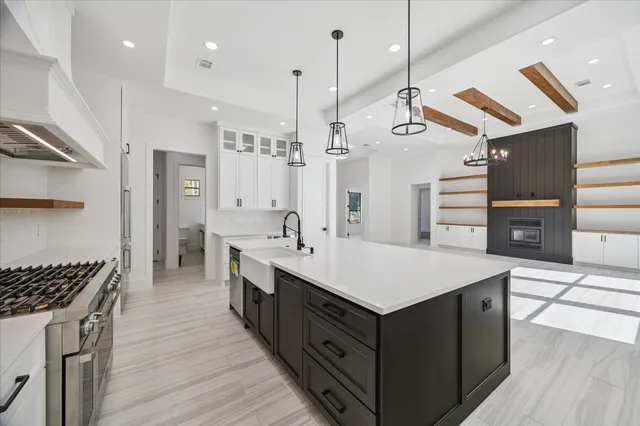 a kitchen with a stove a refrigerator a sink and wooden floor