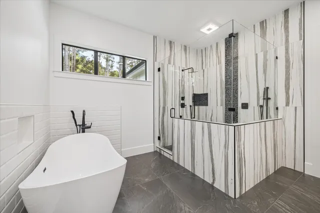 a view of a hallway with wooden floor and entryway