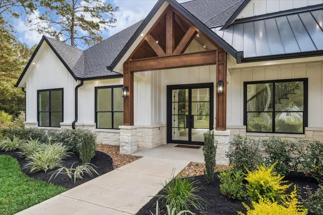 a front view of a house with a yard outdoor seating and mountain view