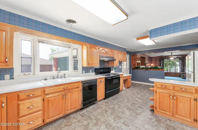 a view of a kitchen with a sink and dishwasher cabinet