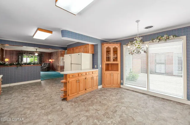 a kitchen with stainless steel appliances granite countertop a stove top oven and refrigerator
