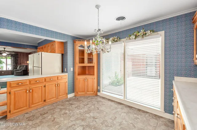 a large kitchen with stainless steel appliances granite countertop a stove a sink and a refrigerator