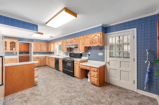 a kitchen with stainless steel appliances granite countertop a stove a sink and a refrigerator