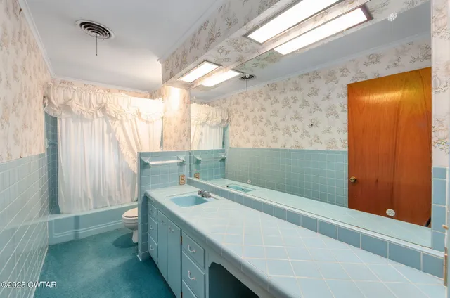 a view of an empty room with a fireplace and a window