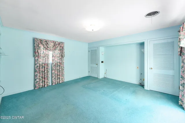 a bathroom with a granite countertop sink a toilet a mirror and shower