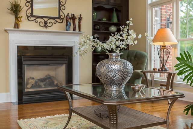 3590 Traveler Road Harrisonburg, VA 22801 - Photo 45 of 50 a vase of flowers sitting on a table with a fireplace