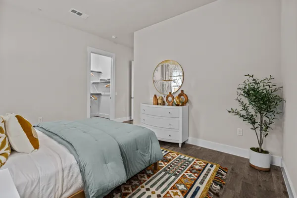 a bedroom with a bed and a potted plant