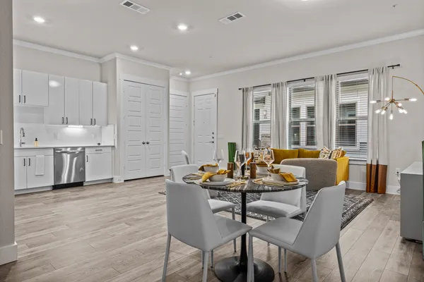 a dining room with furniture and wooden floor