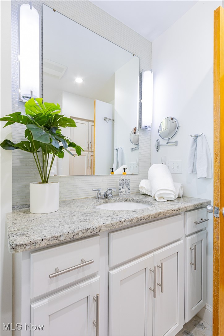 431 Stanley Road Akron, OH 44312 - Photo 13 of 29 Bathroom with vanity and backsplash
