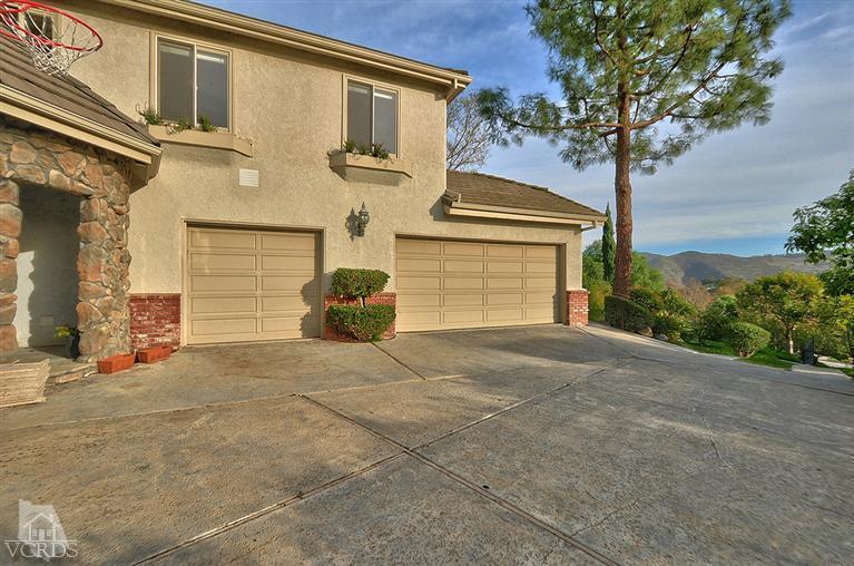 11675 Barranca Road Camarillo, CA 93012 - Photo 15 of 19 a view of a house with a yard and garage