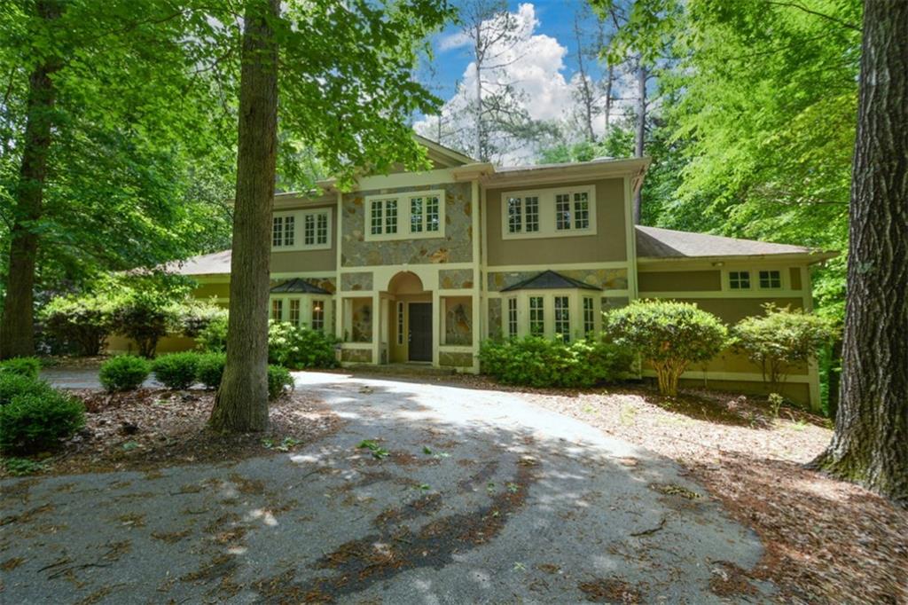 5051 Powers Ferry Road Northwest Sandy Springs, GA 30327 - Photo 1 of 1 a view of a house with a yard and potted plants