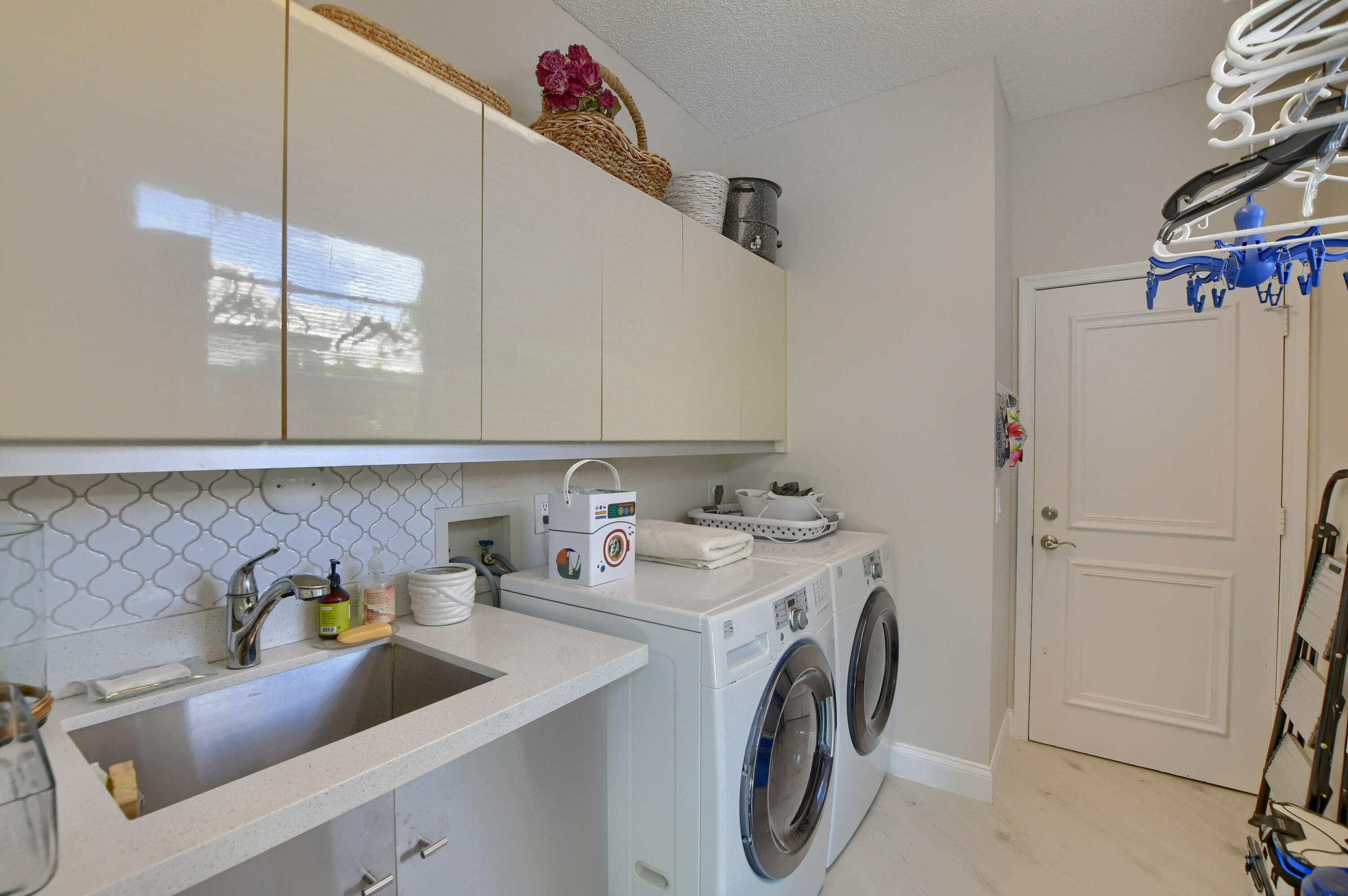 5360 Northwest 20th Avenue Boca Raton, FL 33496 - Photo 18 of 28 a utility room with sink dryer and washer