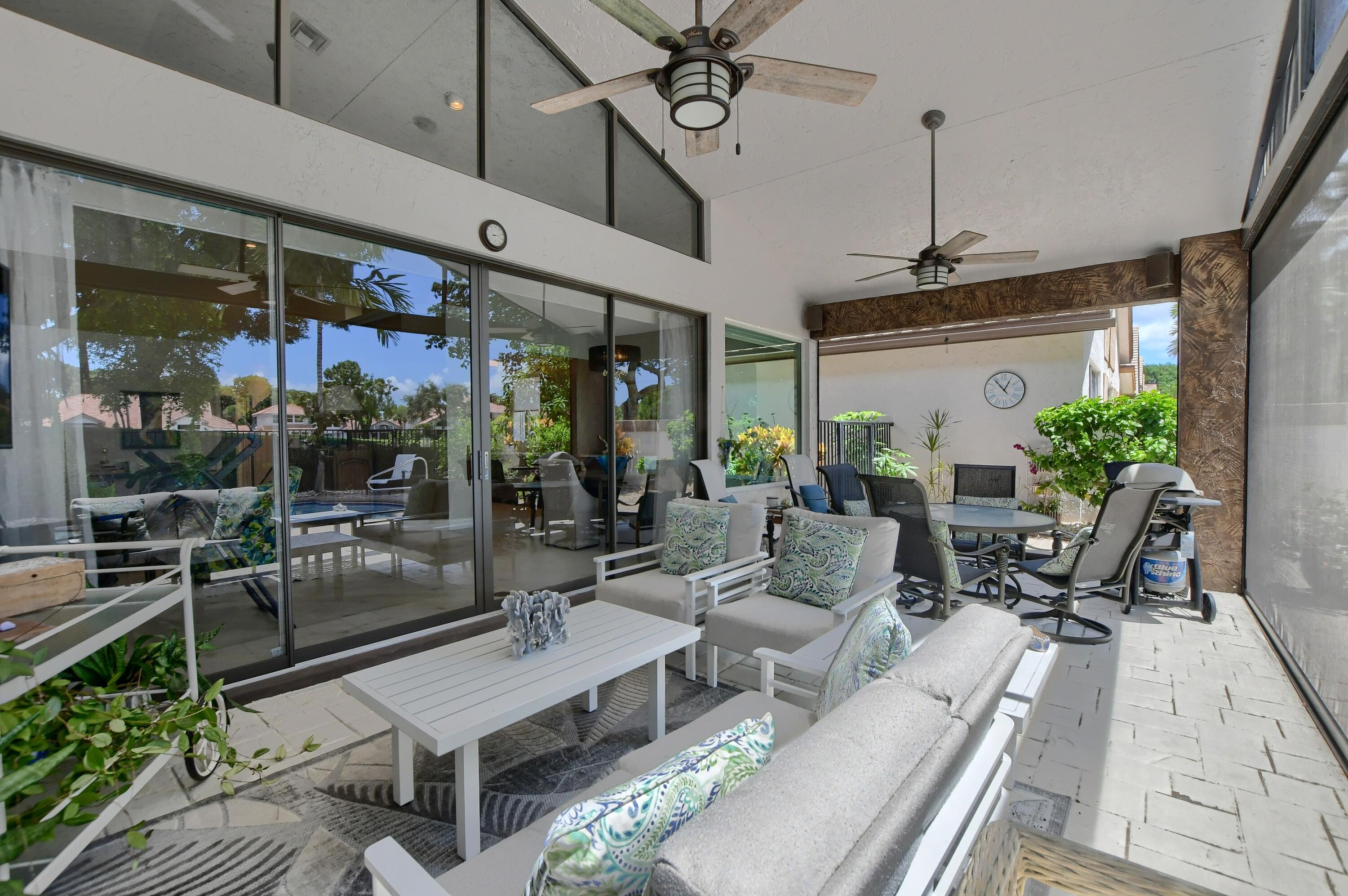 5360 Northwest 20th Avenue Boca Raton, FL 33496 - Photo 20 of 28 a building outdoor space with patio furniture and potted plants