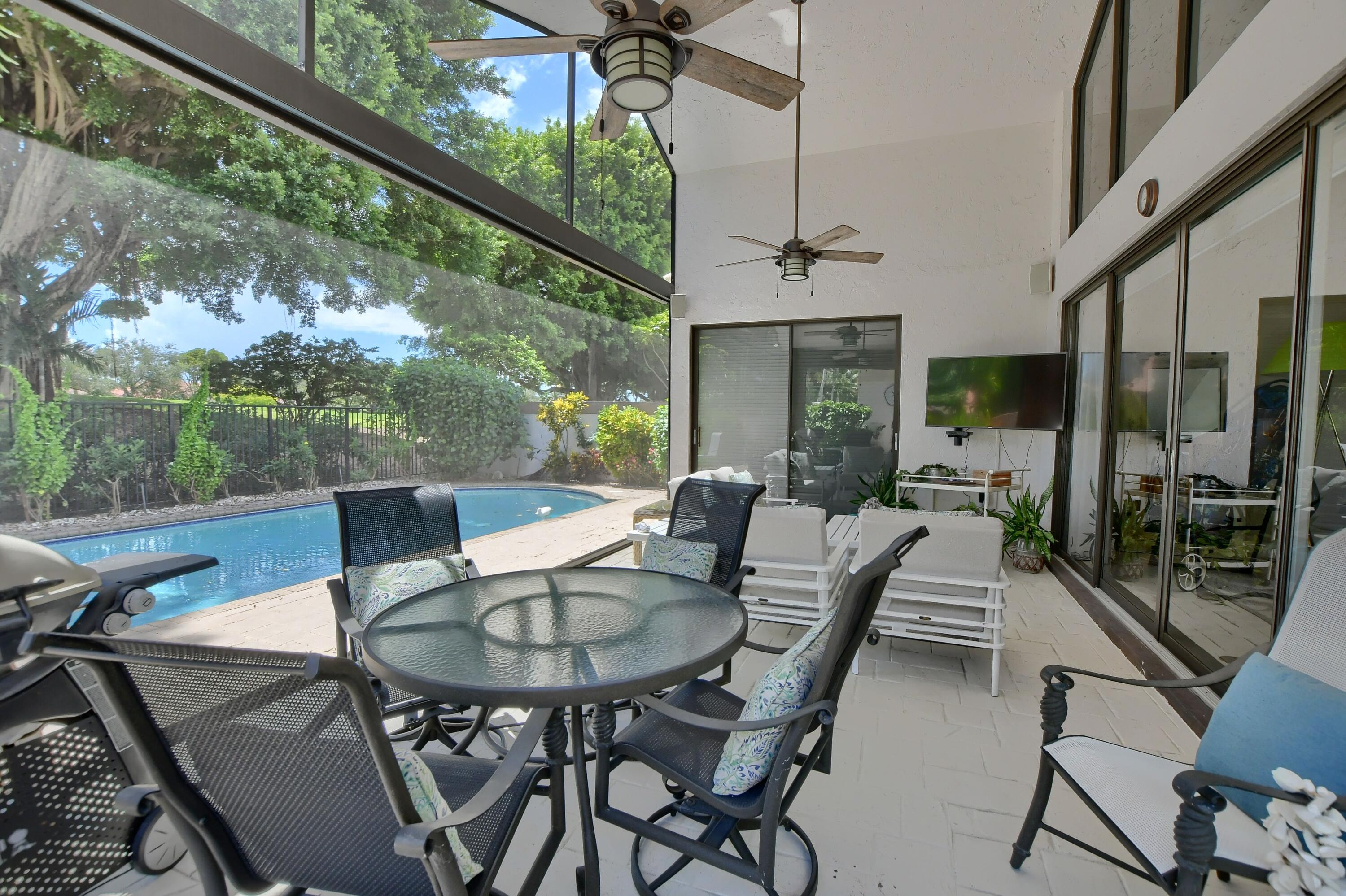 5360 Northwest 20th Avenue Boca Raton, FL 33496 - Photo 21 of 28 a view of a patio with a table and chairs
