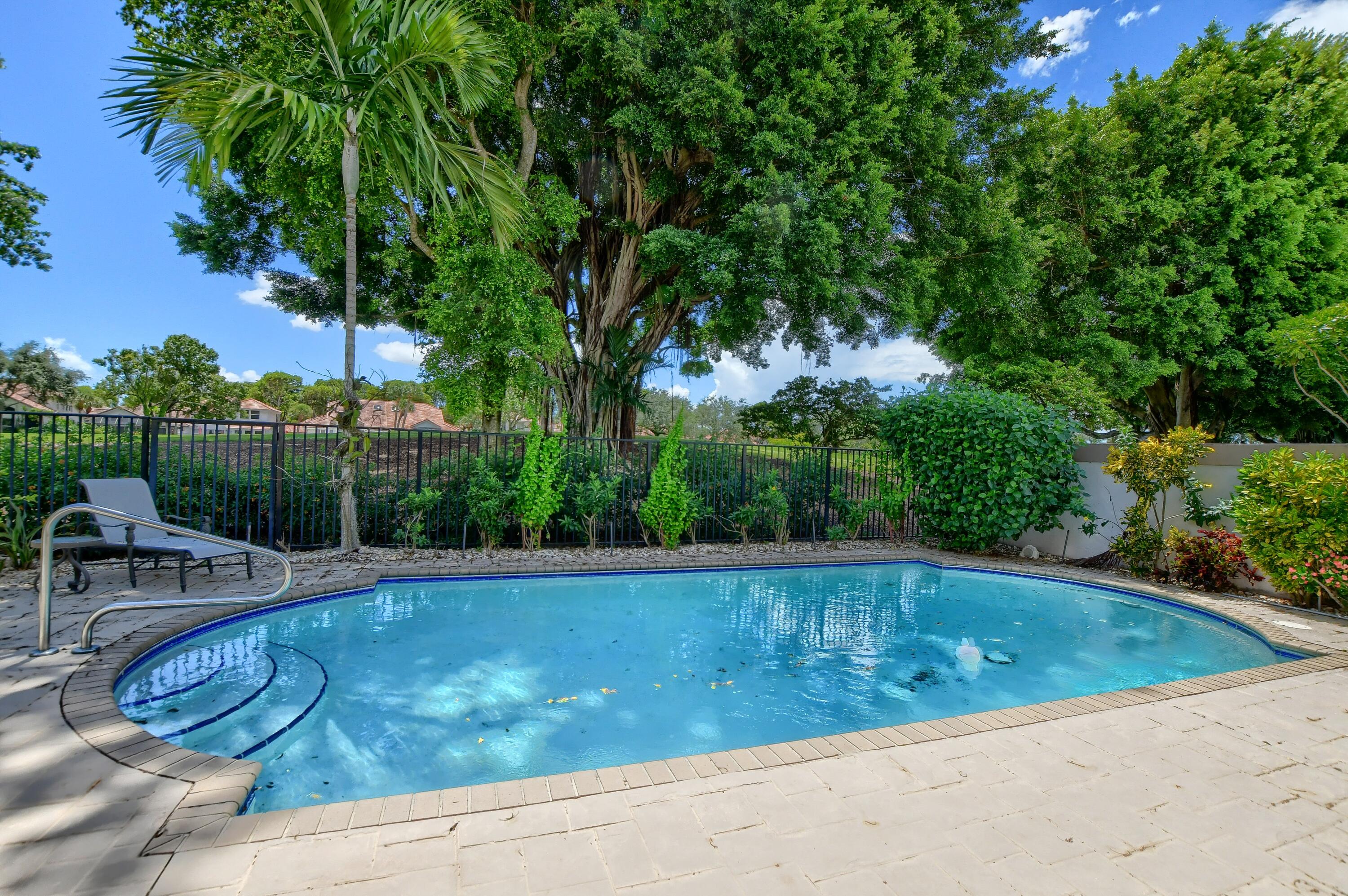 5360 Northwest 20th Avenue Boca Raton, FL 33496 - Photo 24 of 28 a view of a swimming pool with a patio