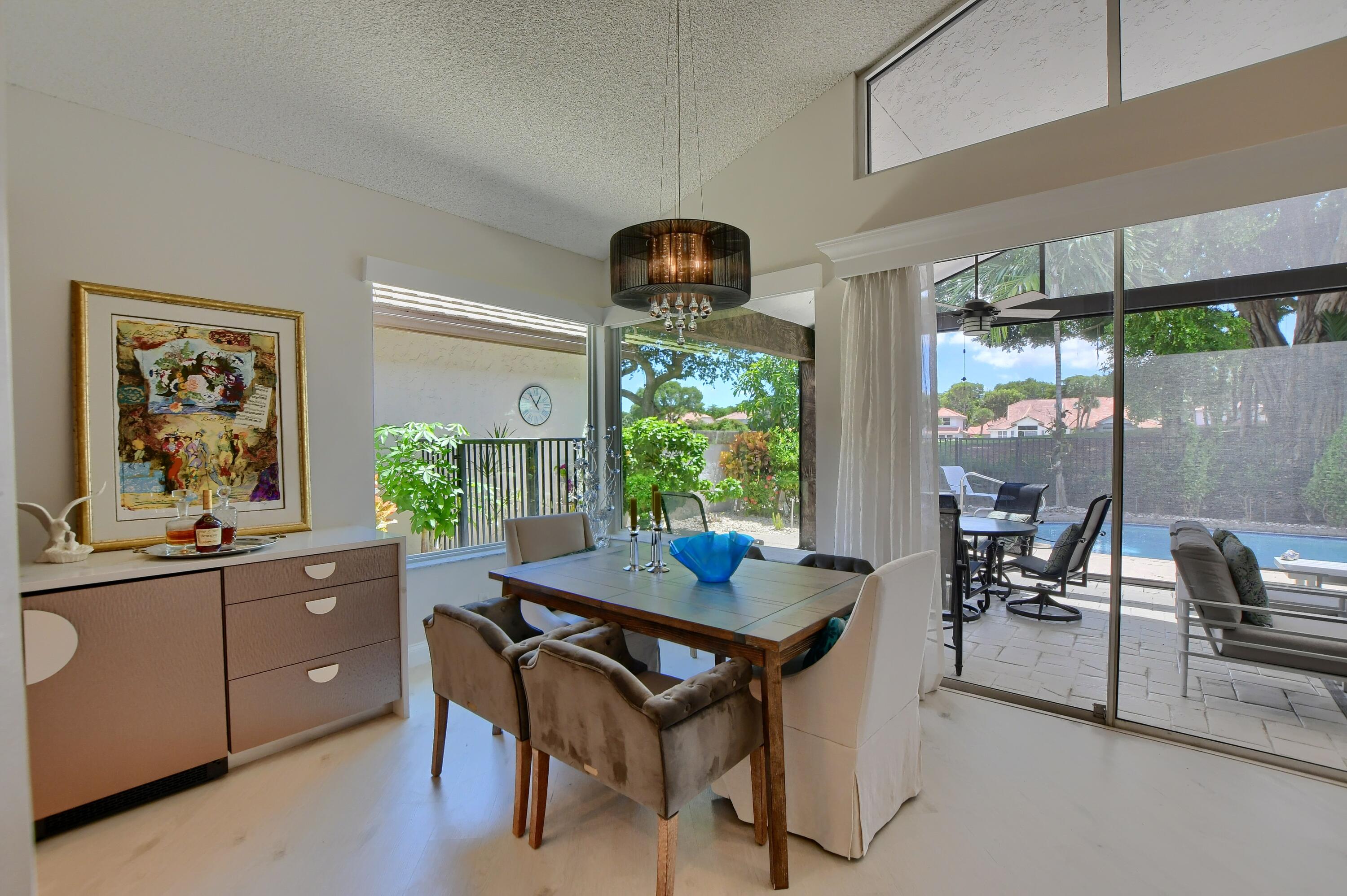 5360 Northwest 20th Avenue Boca Raton, FL 33496 - Photo 7 of 28 a dining room with a table and chairs