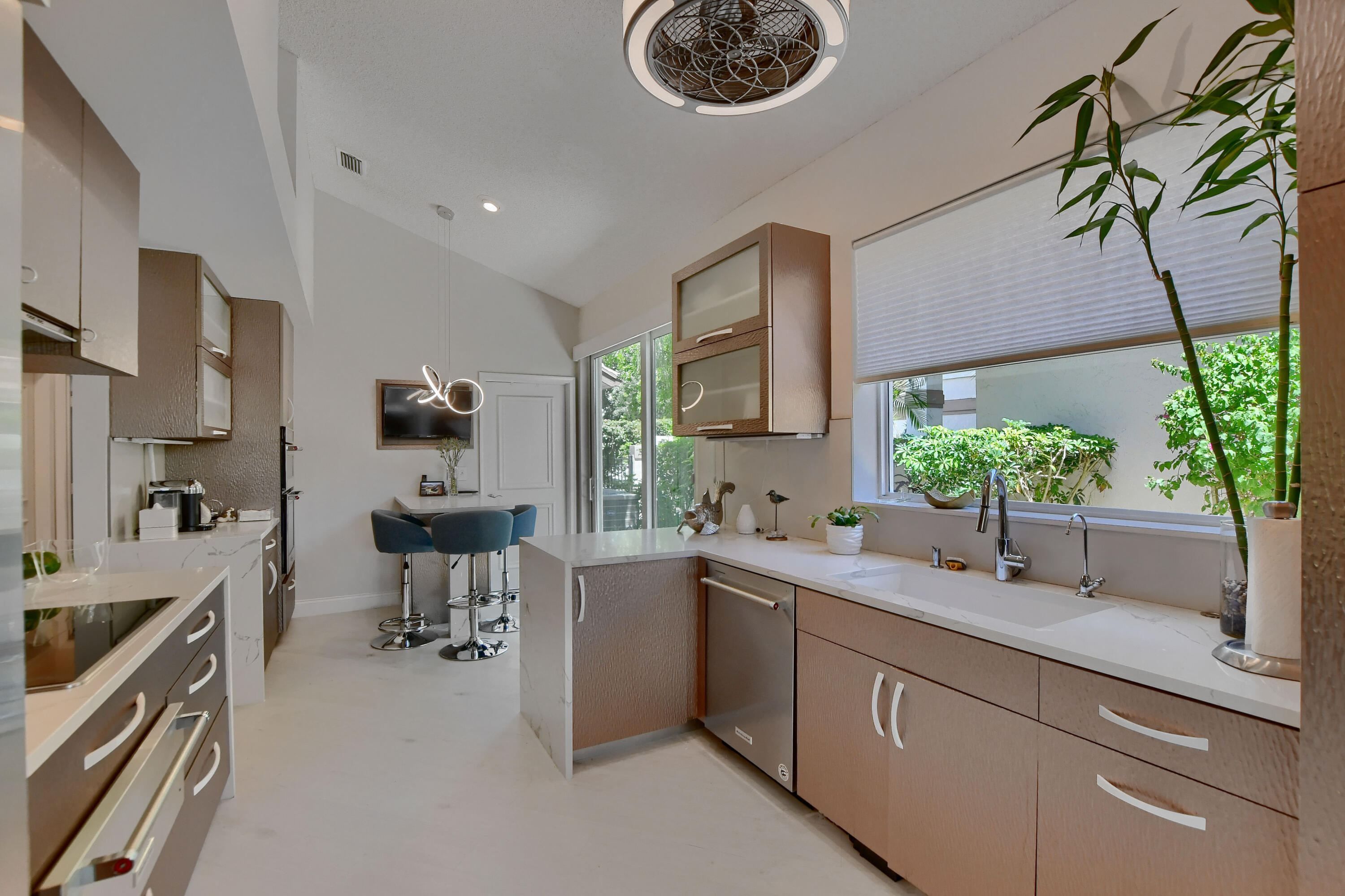 5360 Northwest 20th Avenue Boca Raton, FL 33496 - Photo 9 of 28 a kitchen with a sink stove and cabinets
