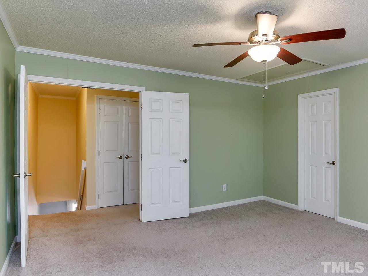 5206 Mountain Ridge Road Raleigh, NC 27612 - Photo 13 of 23 an empty room with closet and a ceiling fan