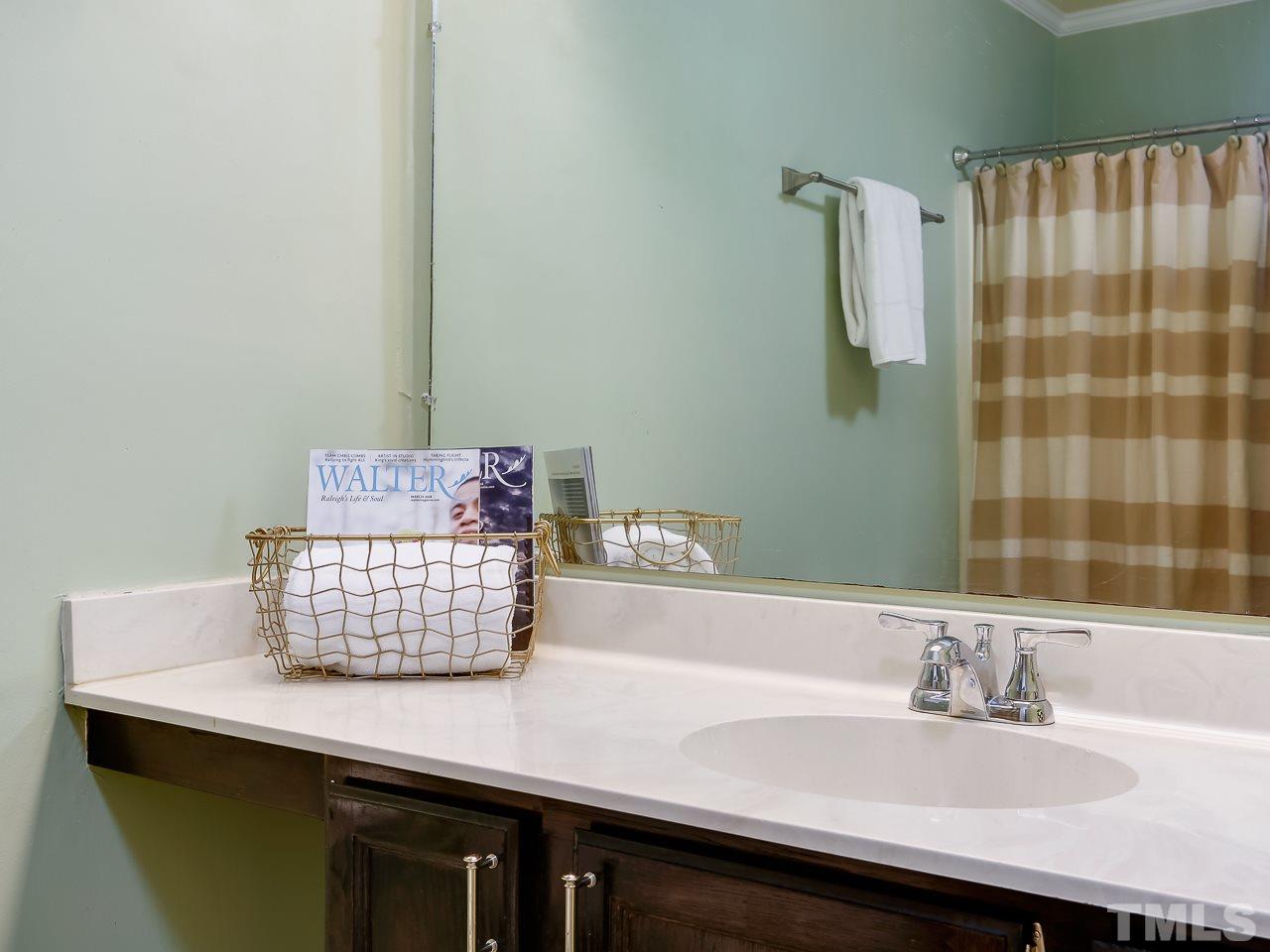 5206 Mountain Ridge Road Raleigh, NC 27612 - Photo 14 of 23 a bathroom with a sink and a mirror