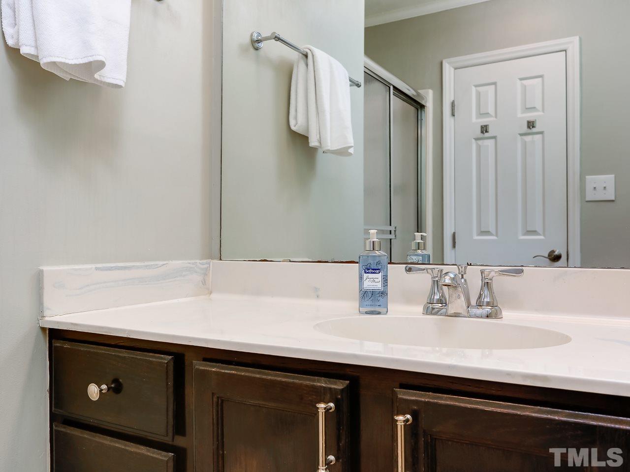 5206 Mountain Ridge Road Raleigh, NC 27612 - Photo 17 of 23 a bathroom with a sink and a mirror