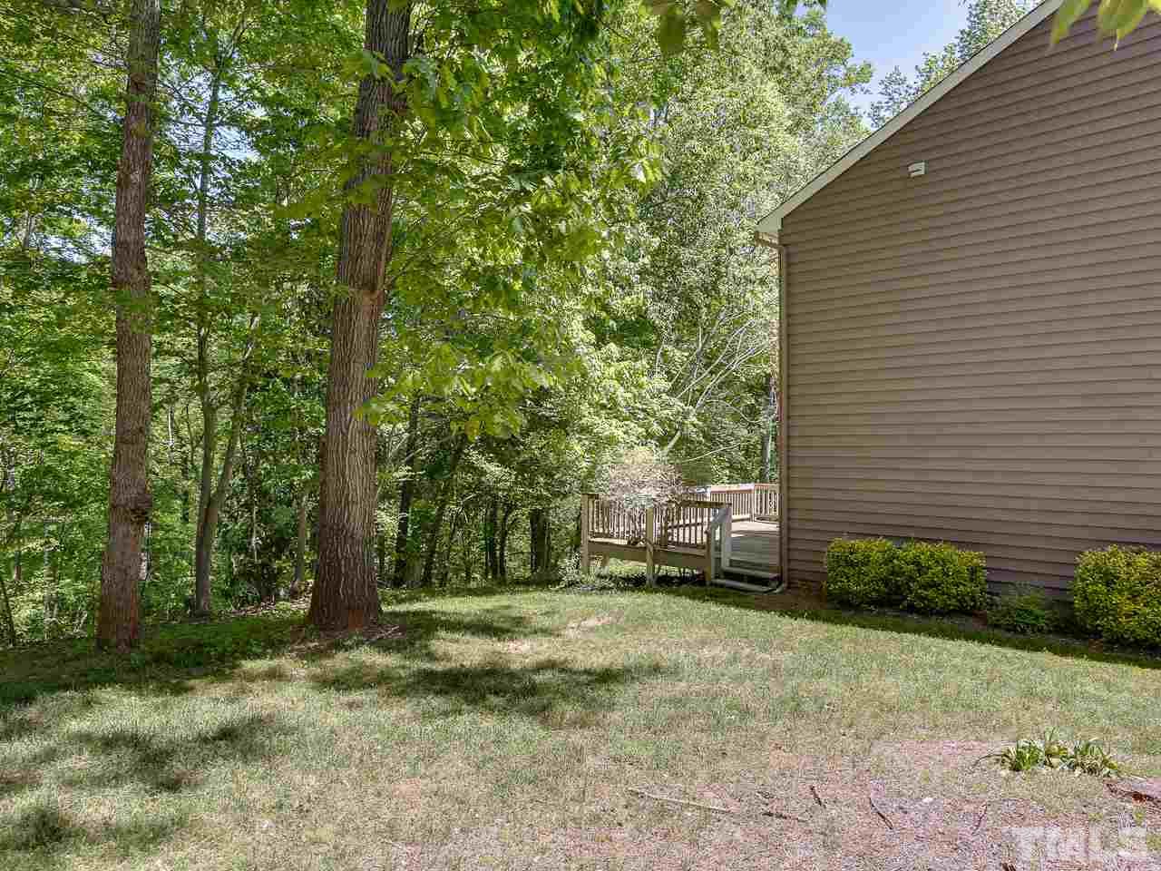 5206 Mountain Ridge Road Raleigh, NC 27612 - Photo 18 of 23 a backyard of a house with lots of green space
