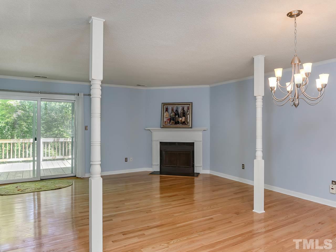 5206 Mountain Ridge Road Raleigh, NC 27612 - Photo 3 of 23 a view of a livingroom with wooden floor a fireplace and windows
