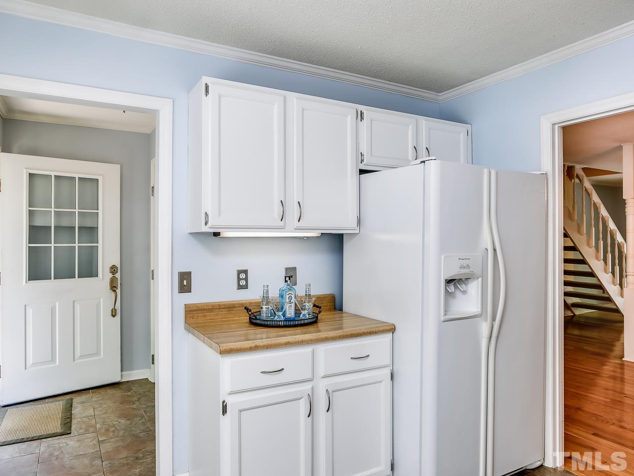 5206 Mountain Ridge Road Raleigh, NC 27612 - Photo 5 of 23 a white refrigerator freezer sitting inside of a kitchen