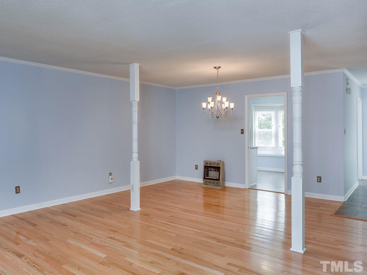 5206 Mountain Ridge Road Raleigh, NC 27612 - Photo 9 of 23 a view of an empty room with wooden floor
