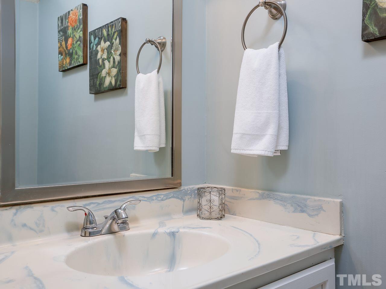 5206 Mountain Ridge Road Raleigh, NC 27612 - Photo 10 of 23 a bathroom with a sink and a mirror