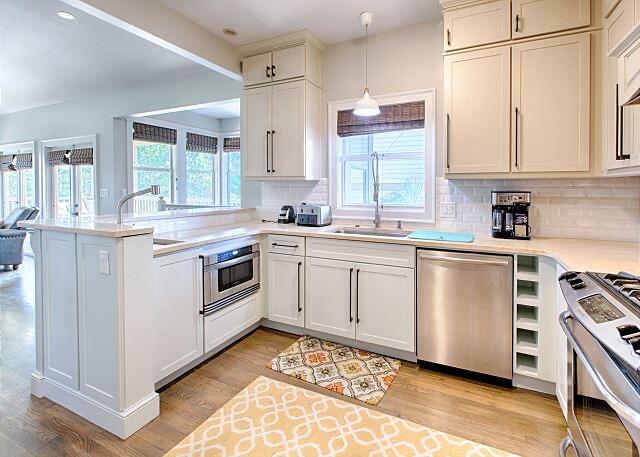 a white kitchen with a stove top oven and sink