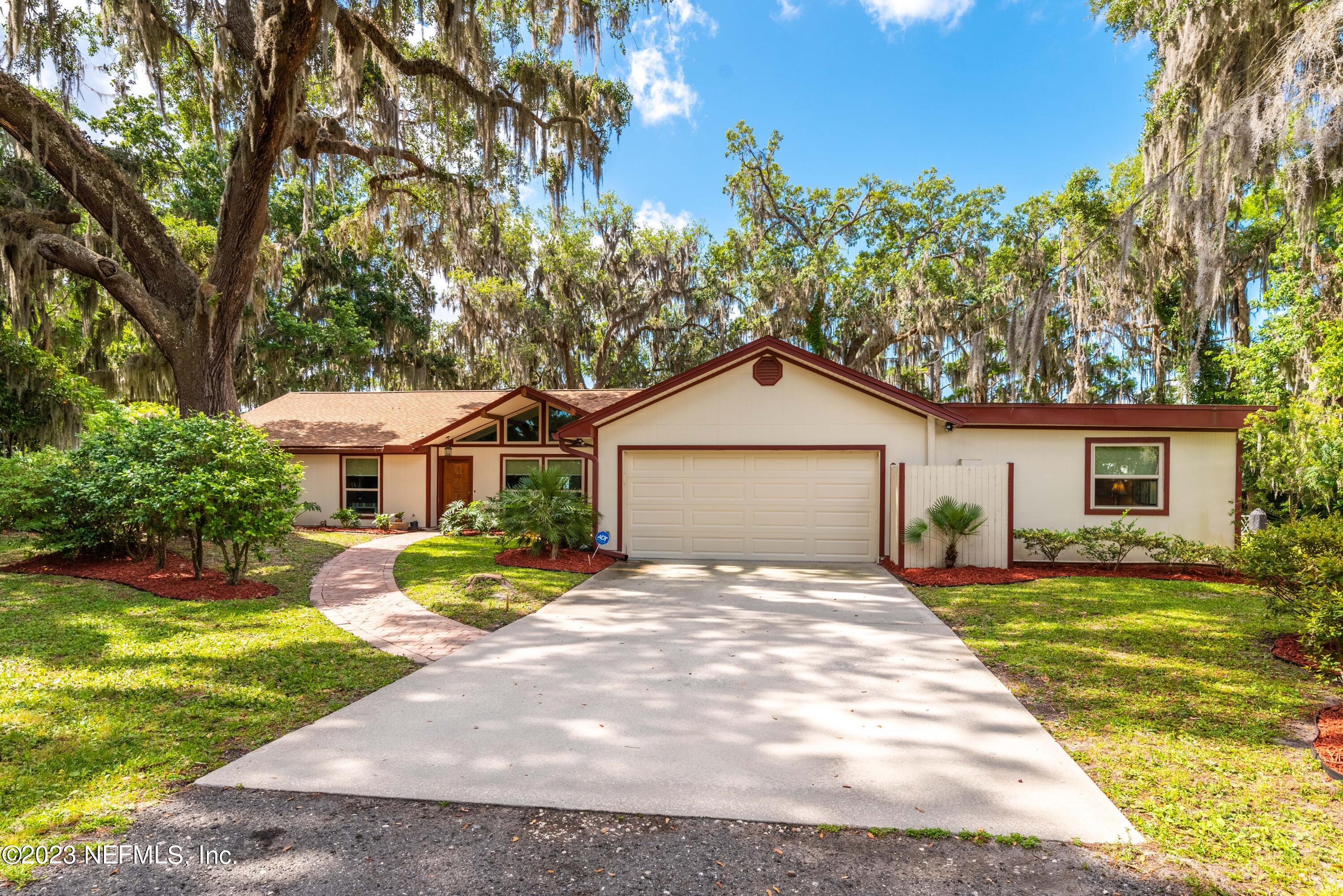 5579 Steamboat Road St. Augustine, FL 32092 - Photo 1 of 52 a front view of a house with a yard and trees
