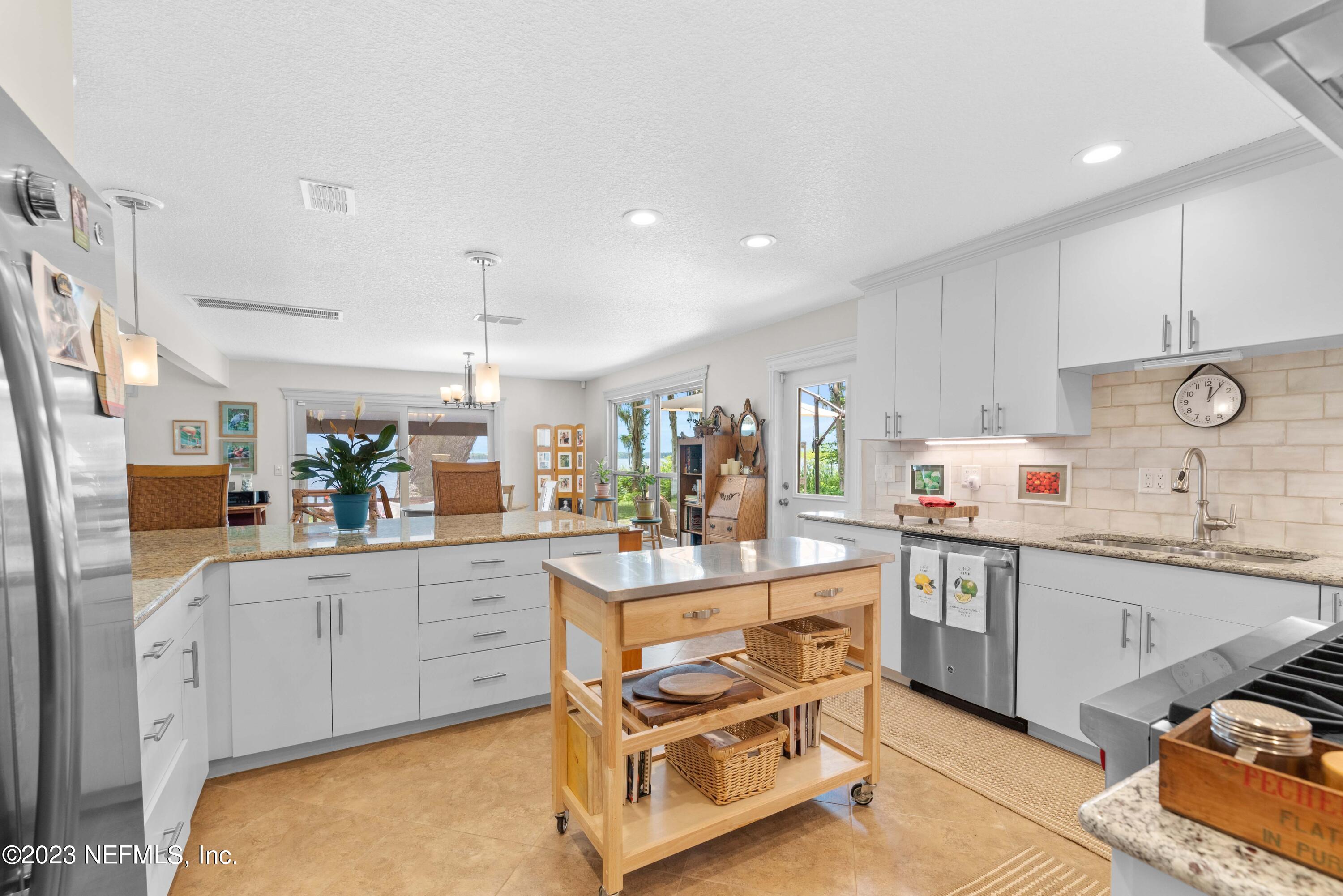 5579 Steamboat Road St. Augustine, FL 32092 - Photo 11 of 52 a kitchen with white cabinets and sink