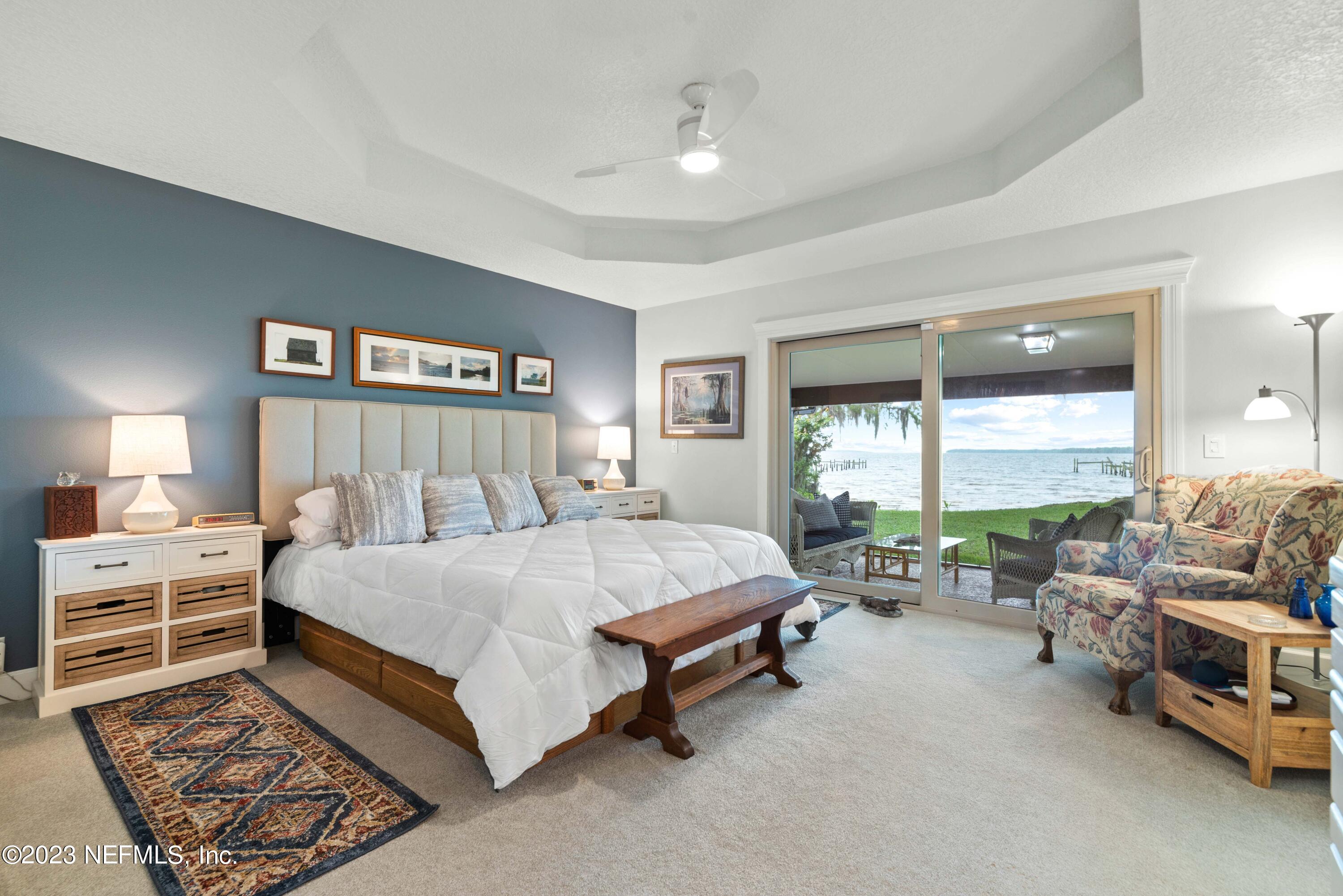 5579 Steamboat Road St. Augustine, FL 32092 - Photo 15 of 52 a bedroom with a bed and a large window