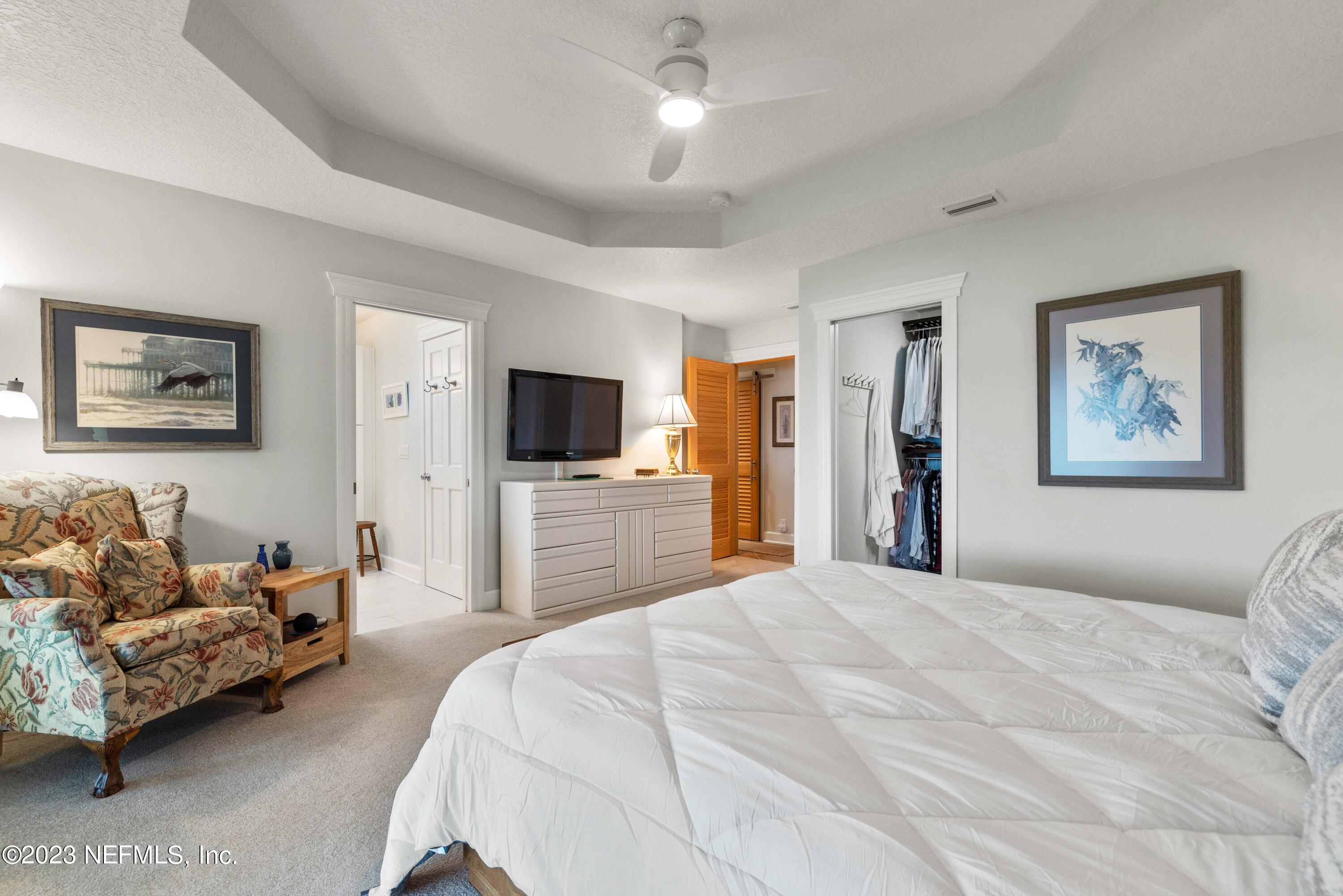 5579 Steamboat Road St. Augustine, FL 32092 - Photo 16 of 52 a bedroom with a bed and a flat screen tv