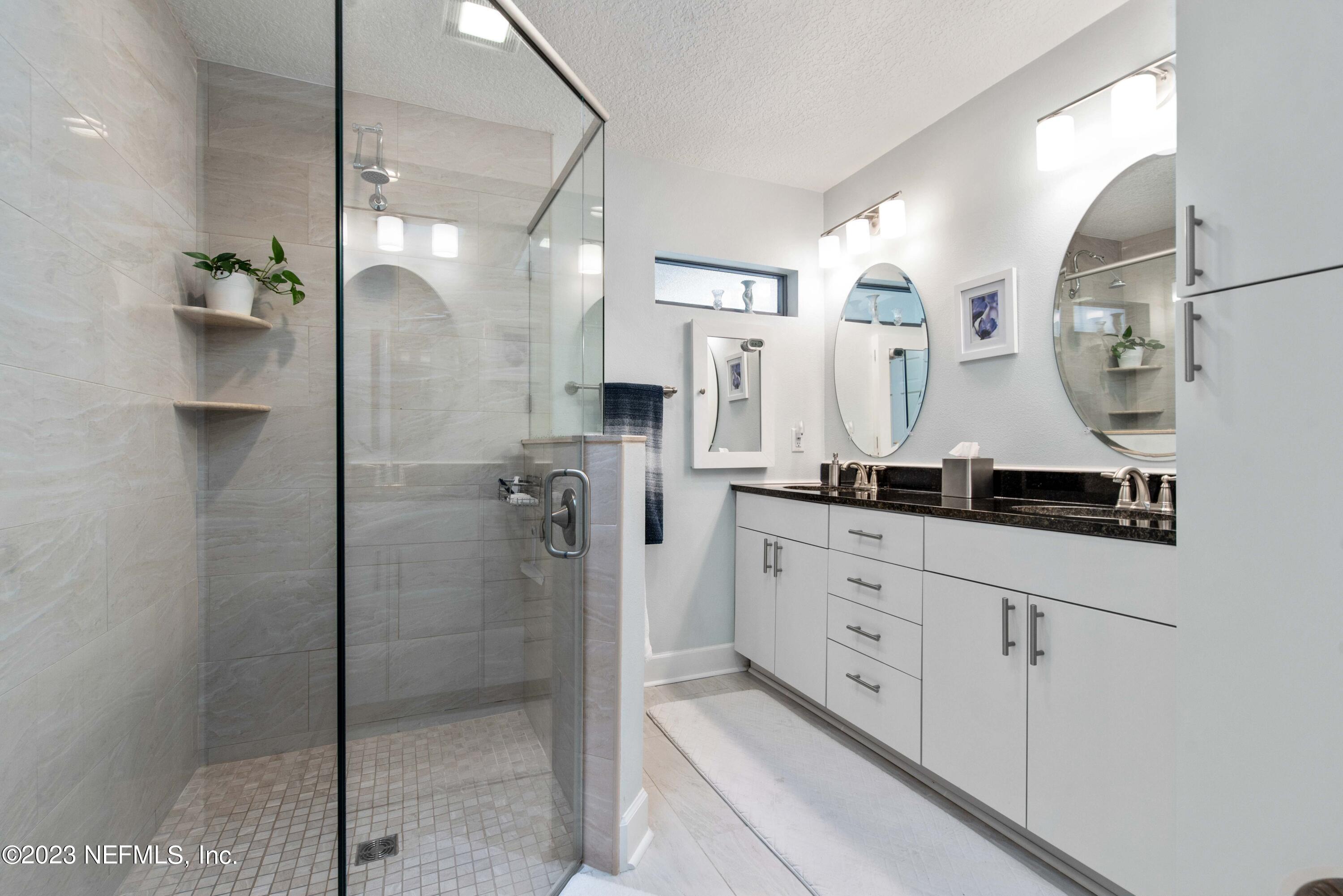 5579 Steamboat Road St. Augustine, FL 32092 - Photo 17 of 52 a bathroom with a double vanity sink and mirror