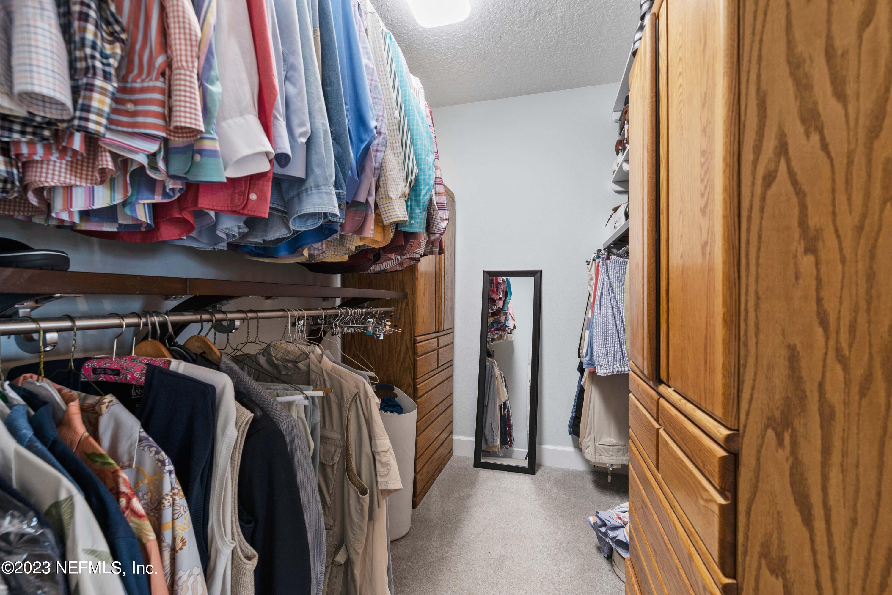 5579 Steamboat Road St. Augustine, FL 32092 - Photo 18 of 52 a view of walk in closet with clothes and shoes