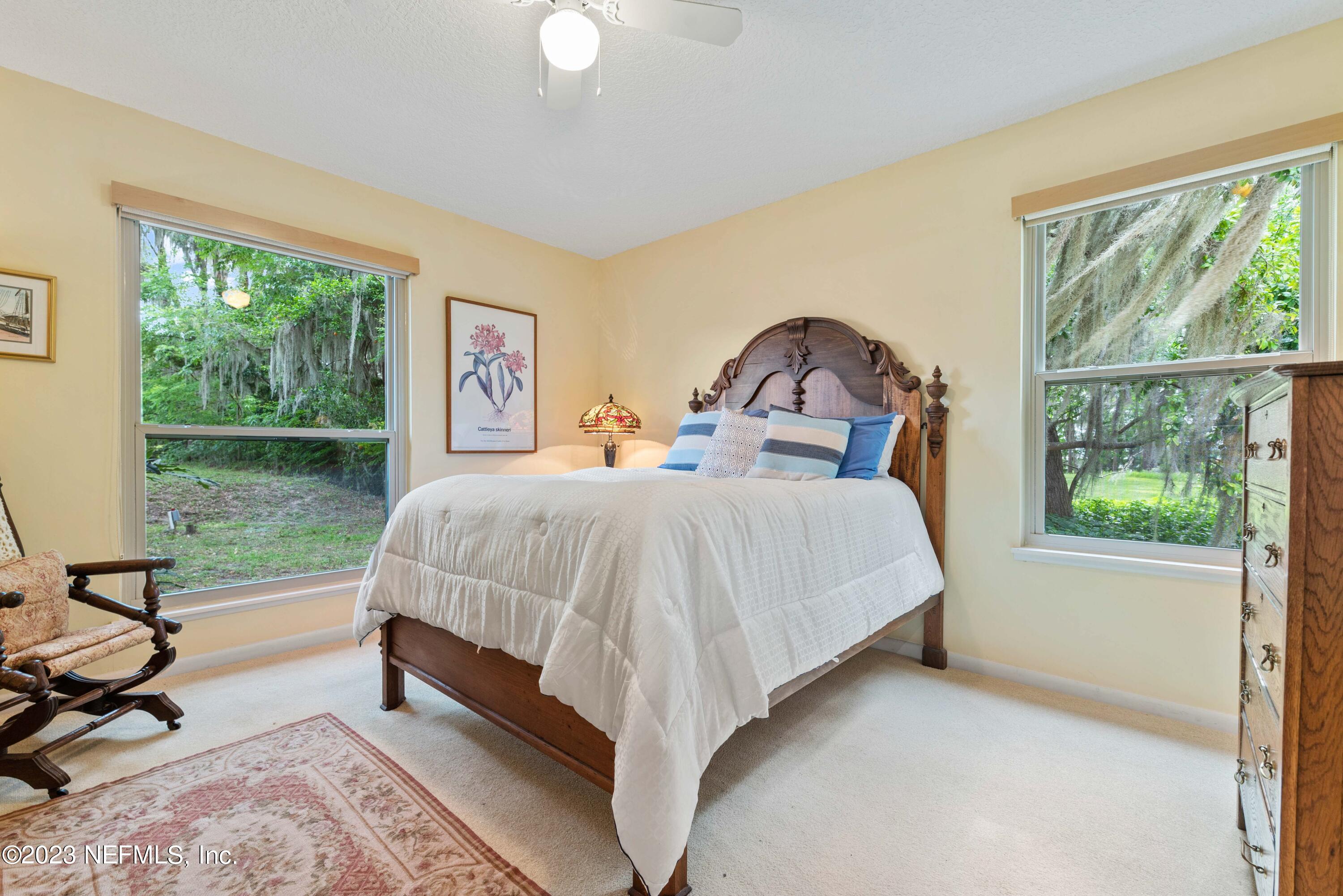 5579 Steamboat Road St. Augustine, FL 32092 - Photo 19 of 52 a bed sitting in a bedroom next to a window