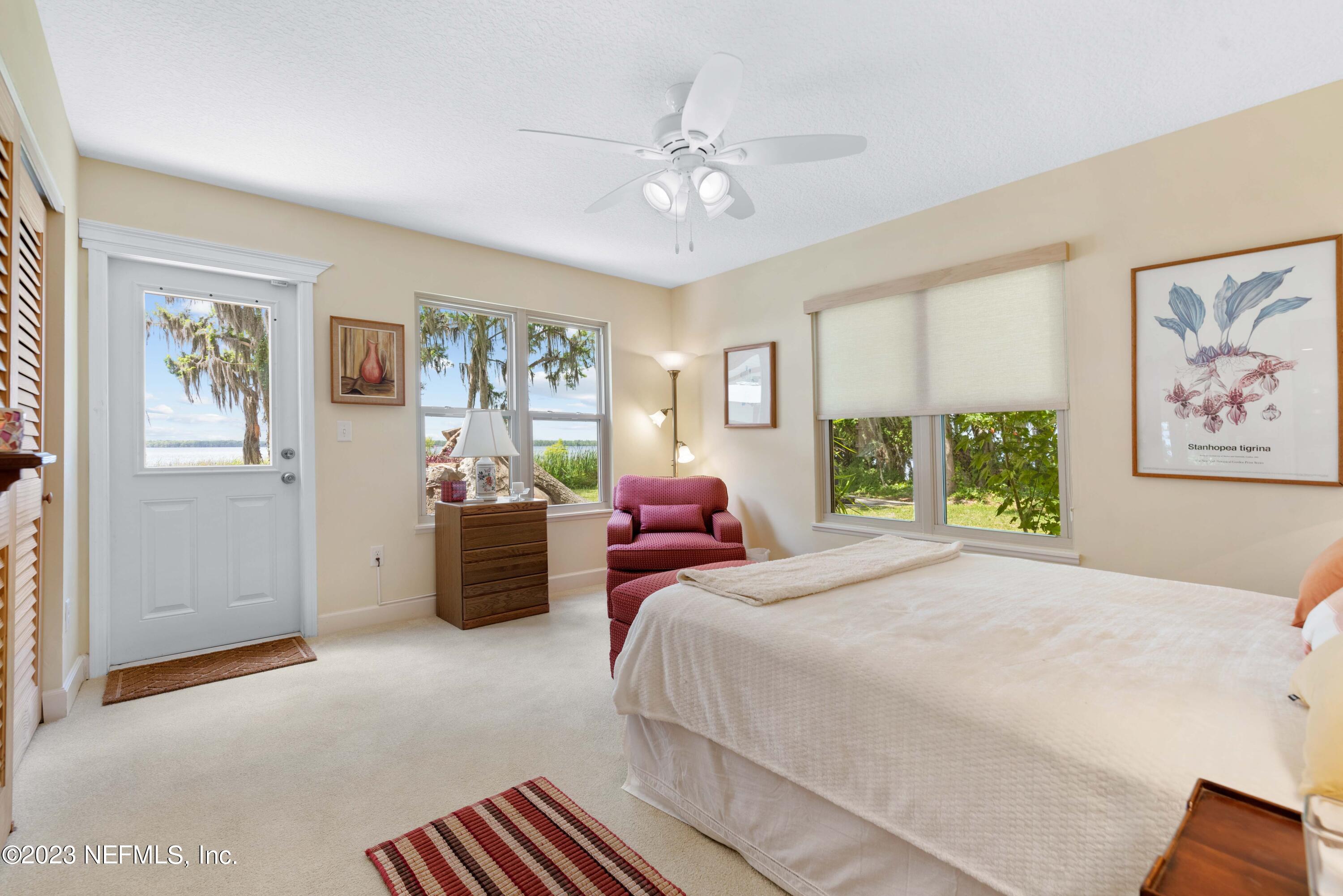 5579 Steamboat Road St. Augustine, FL 32092 - Photo 21 of 52 a bedroom with a large bed and a window