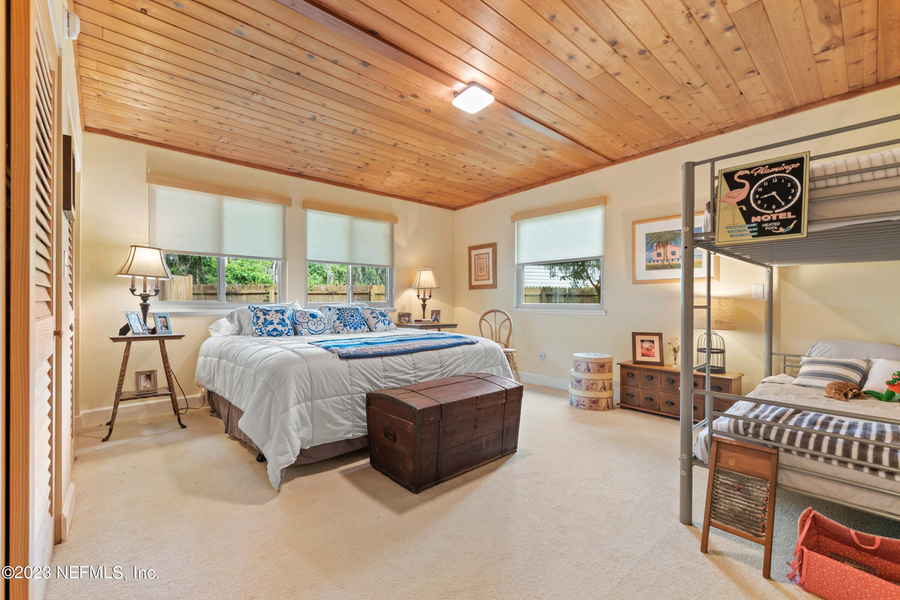 5579 Steamboat Road St. Augustine, FL 32092 - Photo 23 of 52 a spacious bedroom with a bed a dresser and window
