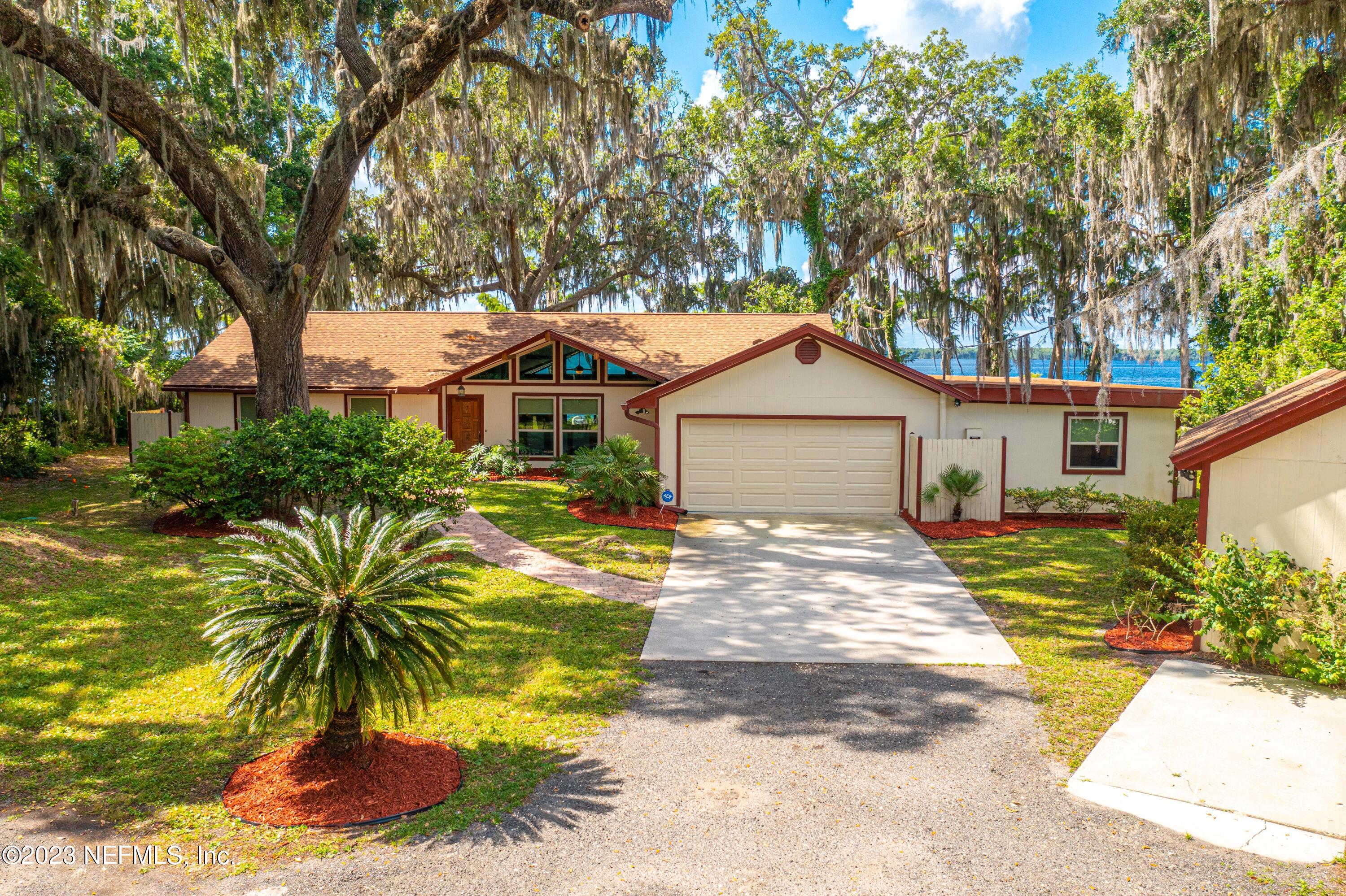 5579 Steamboat Road St. Augustine, FL 32092 - Photo 39 of 52 a front view of a house with a yard and garage