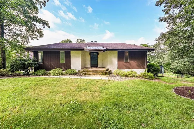 a front view of a house with garden