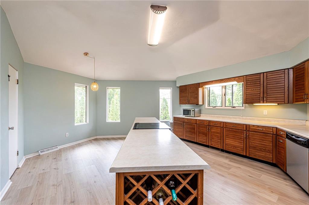 3150 Princeton Road Greensburg, PA 15601 - Photo 15 of 45 a large kitchen with stainless steel appliances granite countertop a sink window and wooden floor