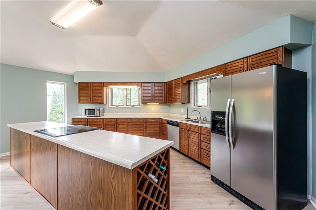 3150 Princeton Road Greensburg, PA 15601 - Photo 17 of 45 a kitchen with stainless steel appliances granite countertop a refrigerator a sink a stove and island