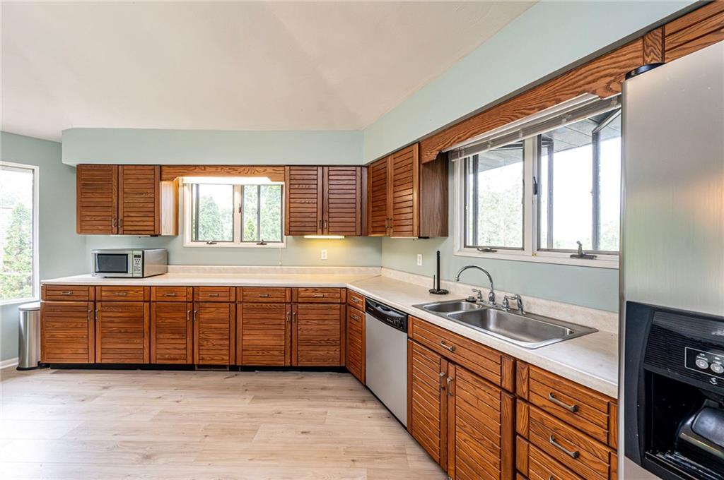 3150 Princeton Road Greensburg, PA 15601 - Photo 19 of 45 a large kitchen with kitchen island granite countertop a large window sink and cabinets