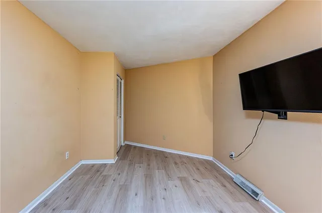 a view of room with wooden floor and fan