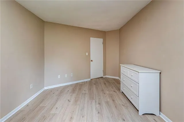 a view of an empty room and wooden floor