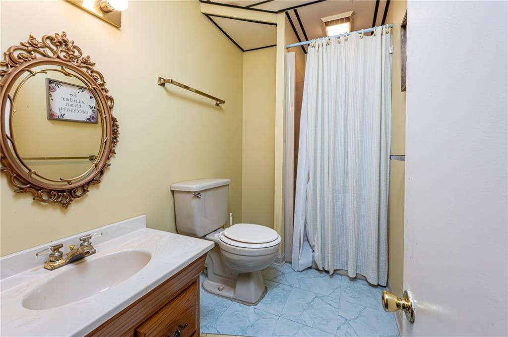 3150 Princeton Road Greensburg, PA 15601 - Photo 40 of 45 a bathroom with a sink a toilet and a mirror