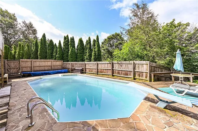 a view of a swimming pool with a backyard