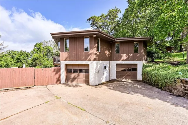 a view of a house with a yard and tree